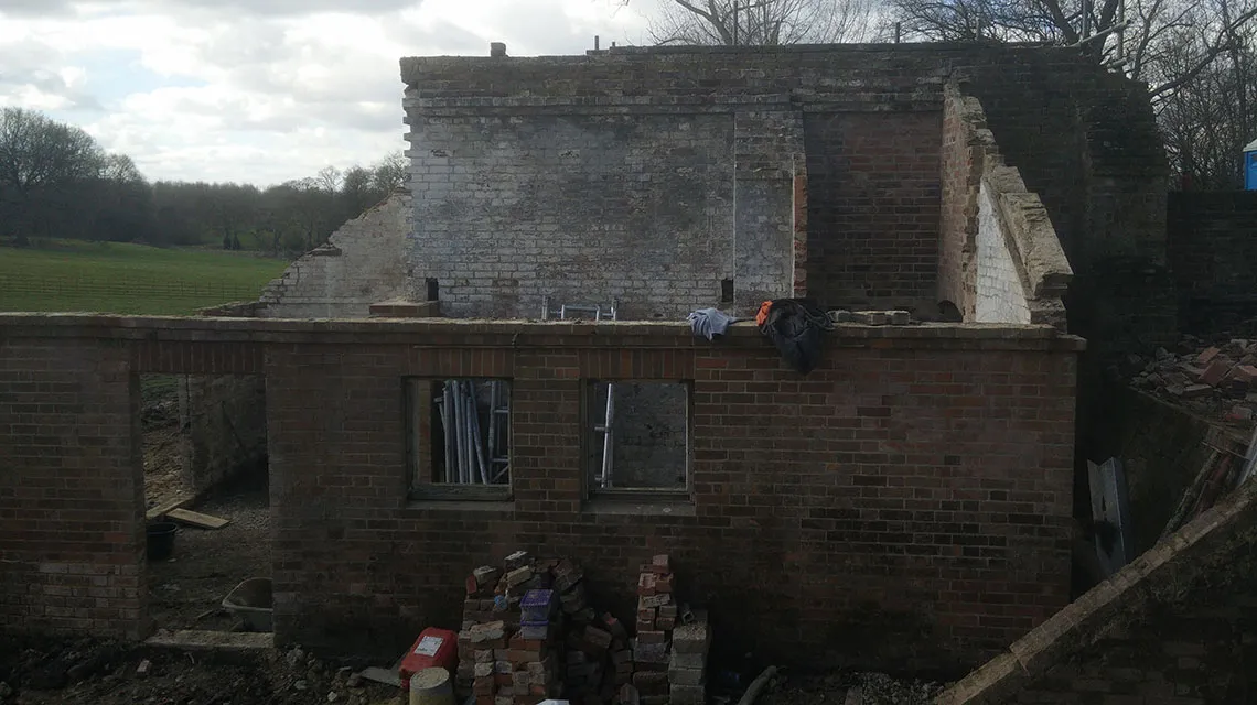 Building reduced to core structure from side.
